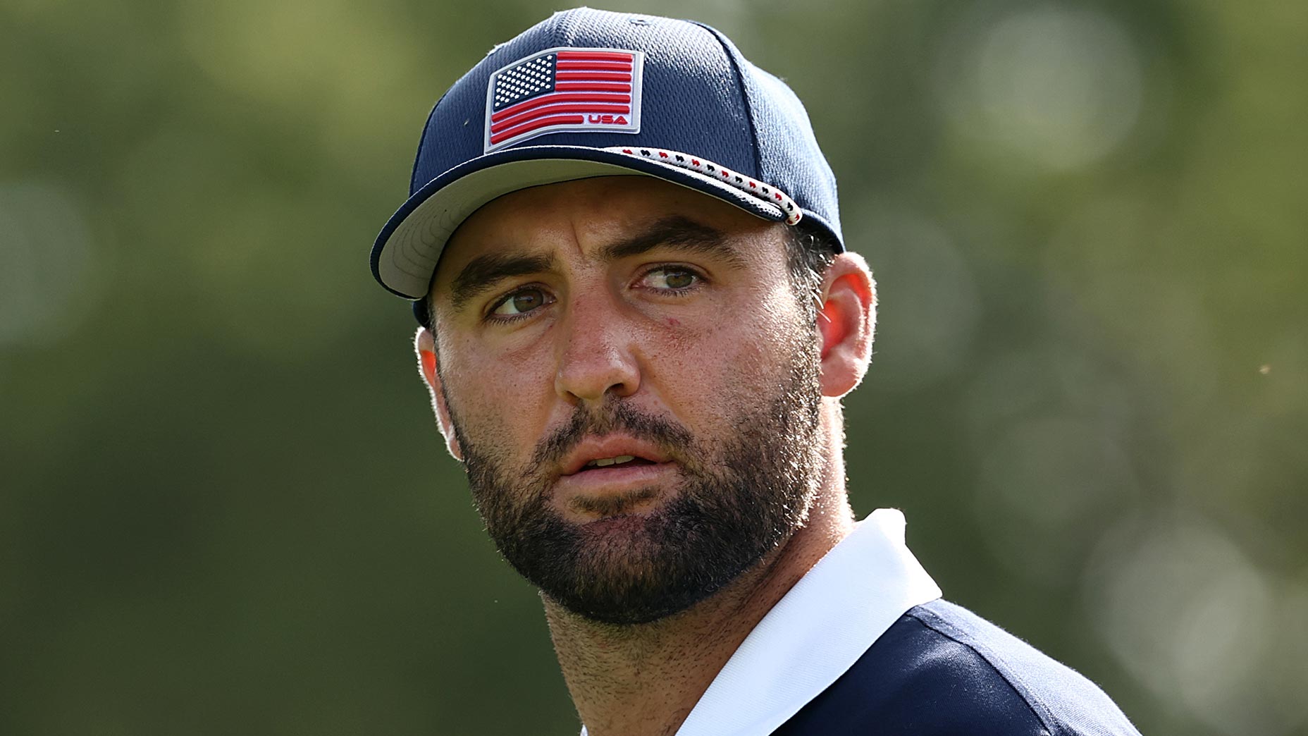 scottie scheffler stares in the distance at the ryder cup at bethpage black