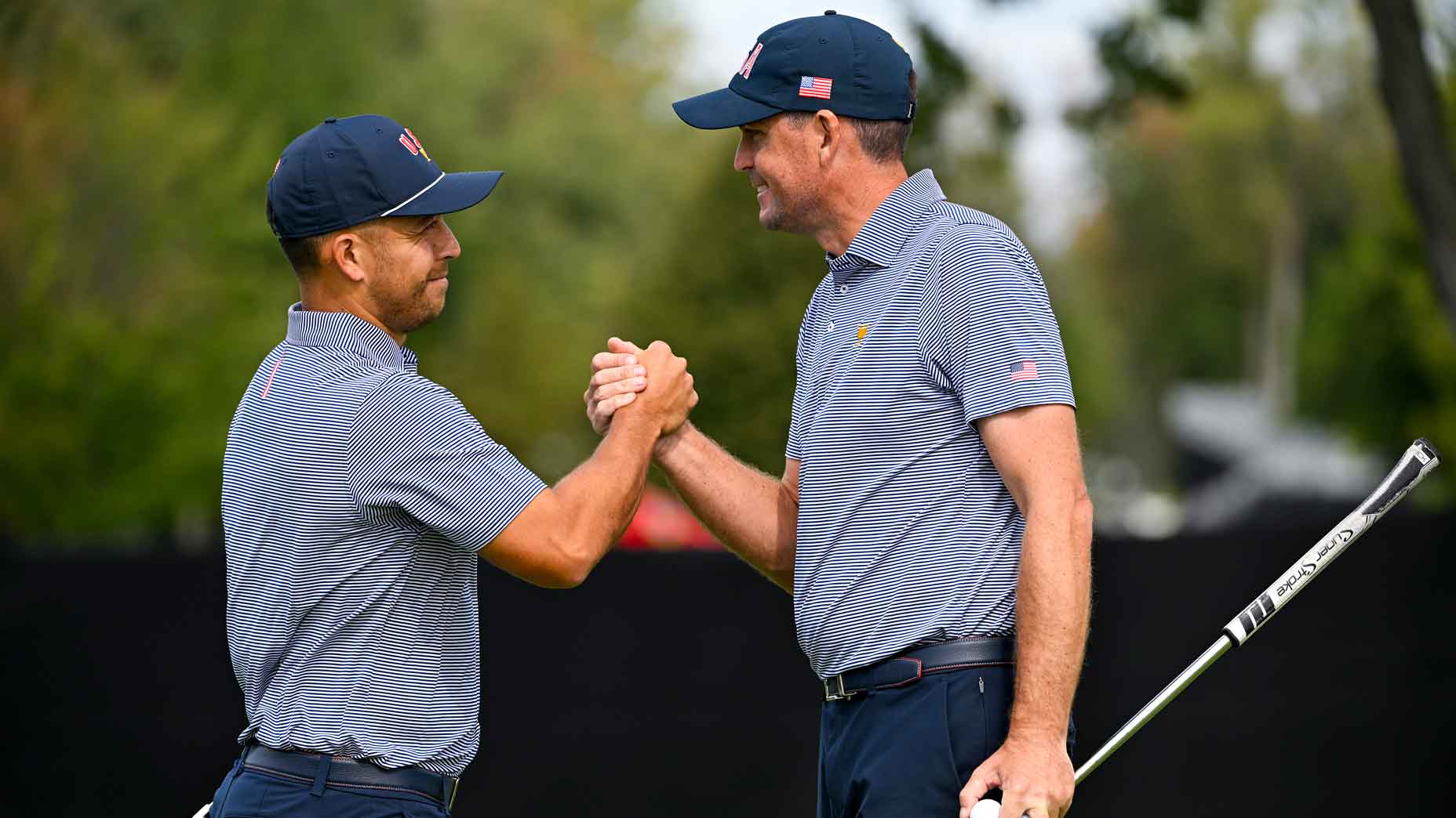 Xander Schauffele of the U.S. Team shakes hands with Keegan Bradley of the U.S. Team on the ninth green prior to the 2024 Presidents Cup at The Royal Montreal Golf Club on September 24, 2024 in Montreal, Quebec. (Photo by Ben Jared/PGA TOUR via Getty Images)