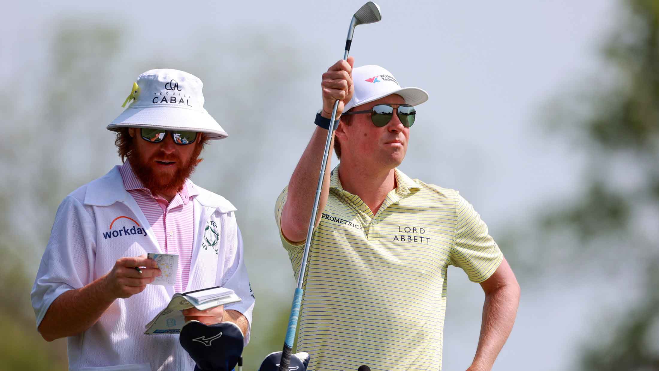 en Griffin of Chapel Hill, North Carolina selects his club next to his caddie on the 10th fairway during the final round of the Memorial Tournament