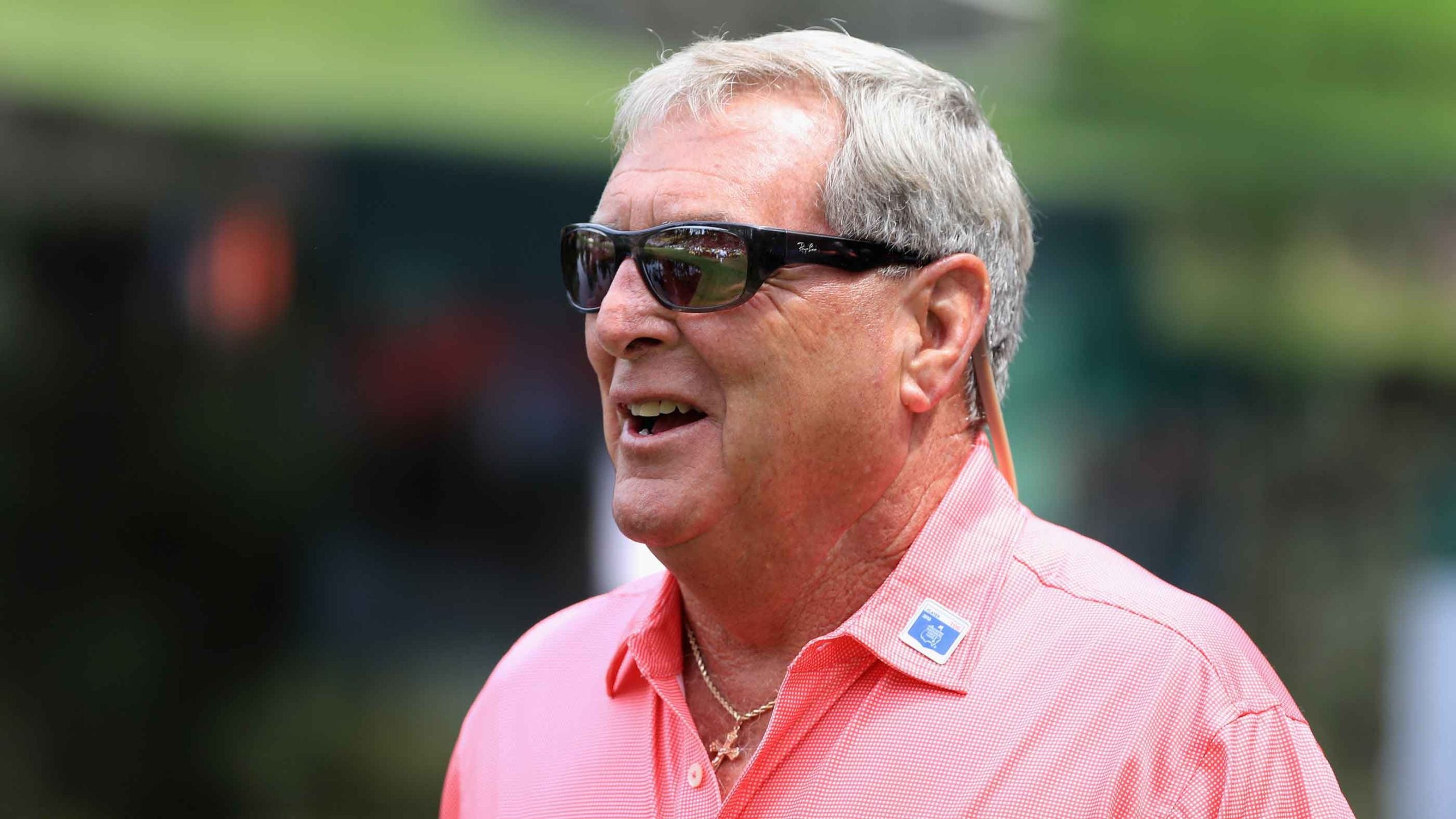 Fuzzy Zoeller walks to a green during the par 3 contest prior to the start of the 2016 Masters