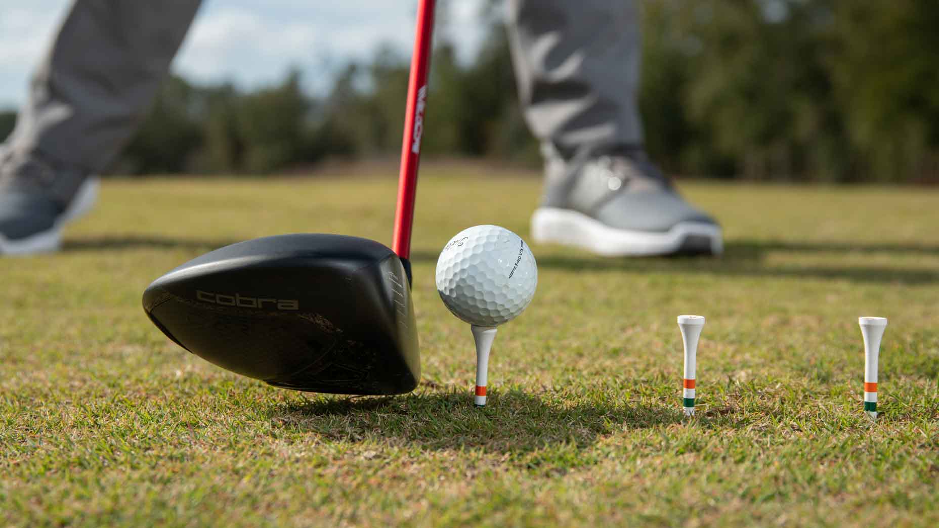 Use this threetee setup to see if a flatter path through impact works for you.