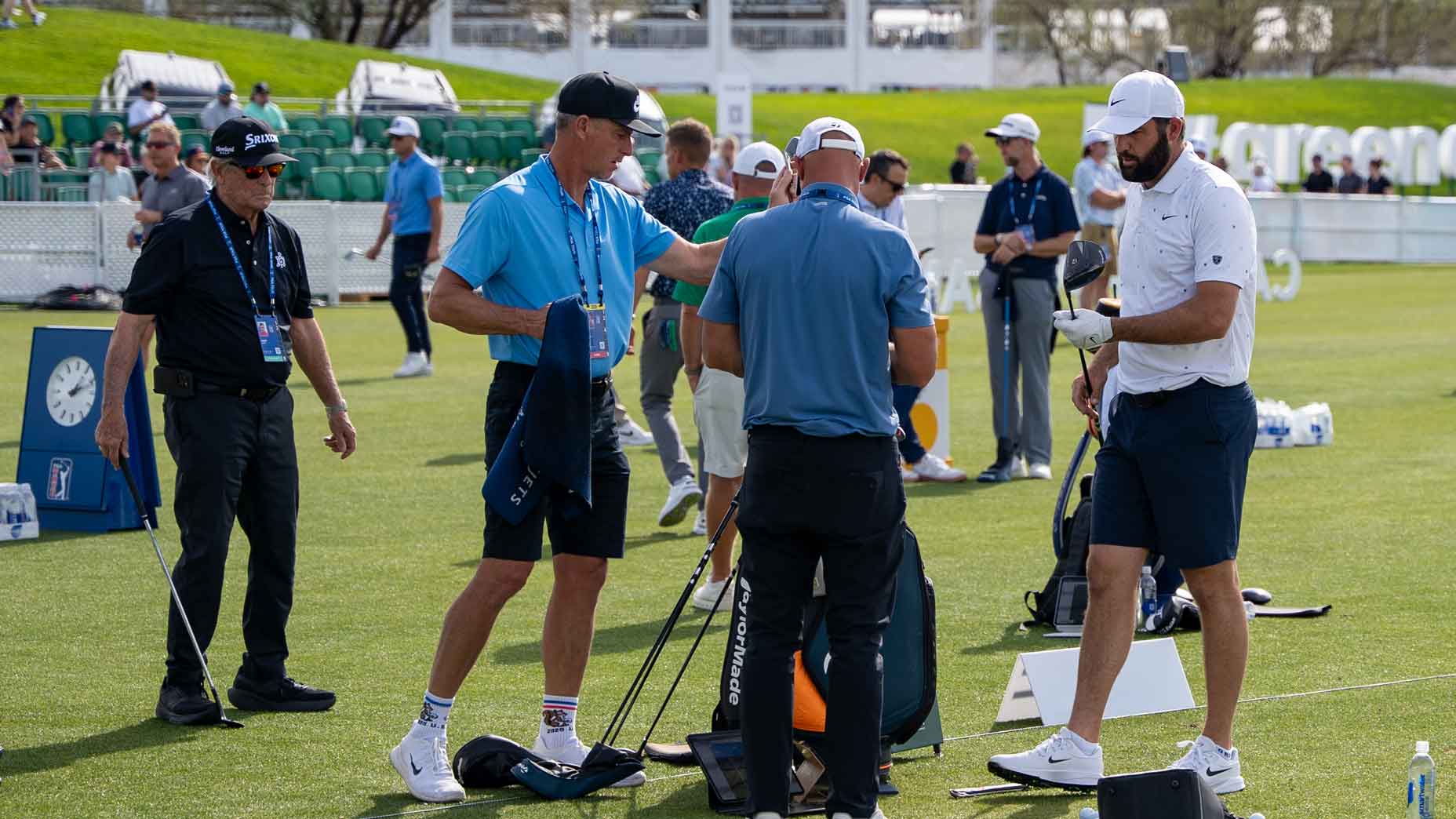 Scottie Scheffler on the range testing drivers with caddie Ted Scott, coach Randy Smith and TaylorMade's Adrian Rietveld.