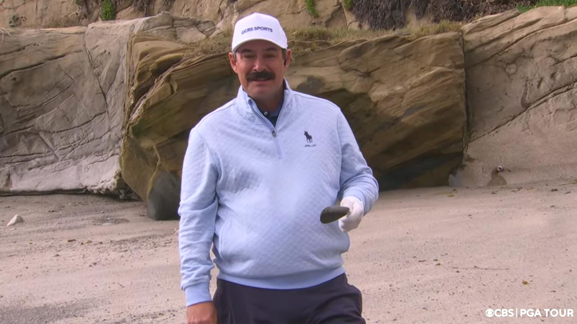 johnson wagner holds wedge on the beach at Pebble Beach in California.
