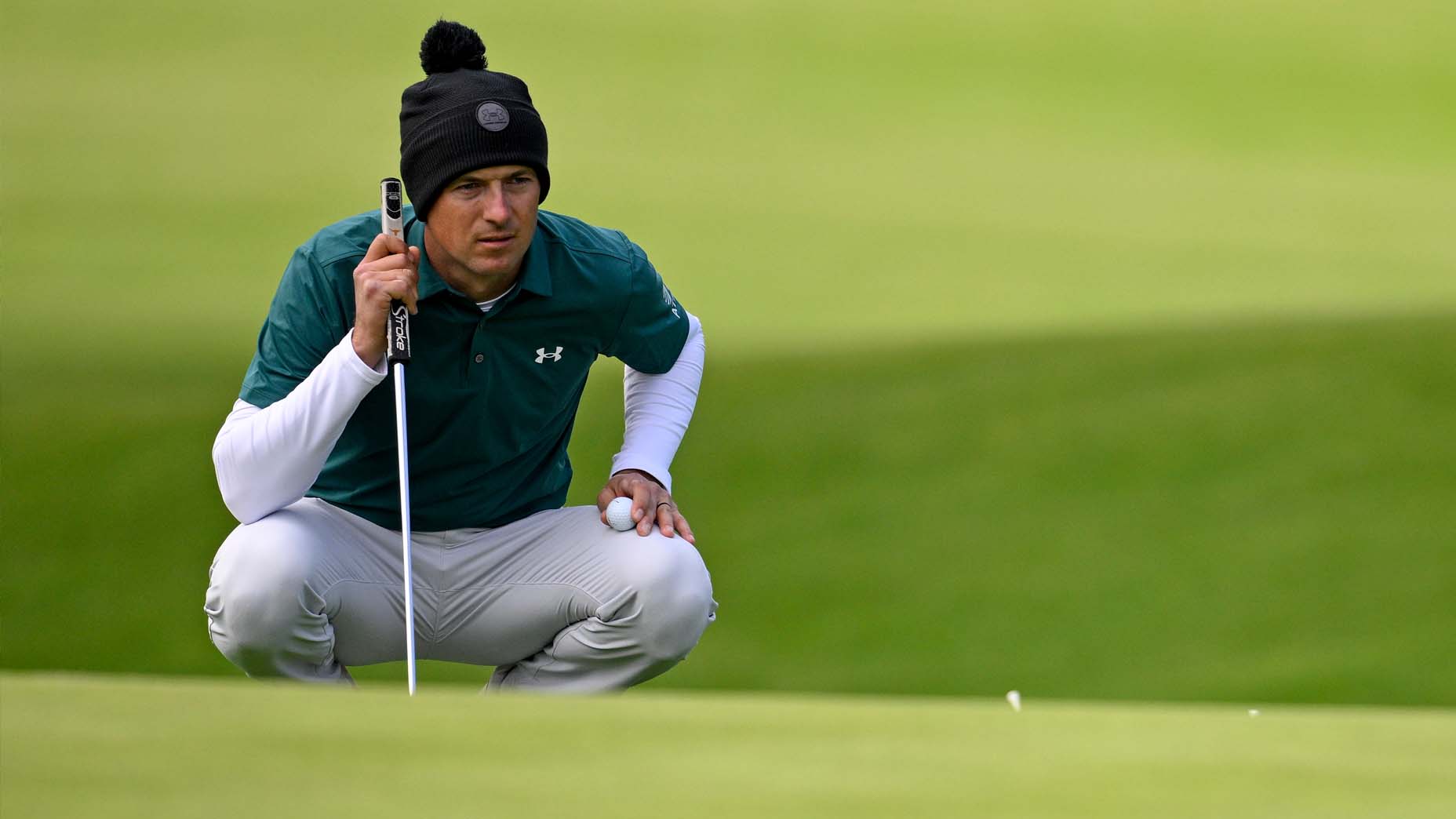 Jordan Spieth lines up a putt at the Genesis Invitational