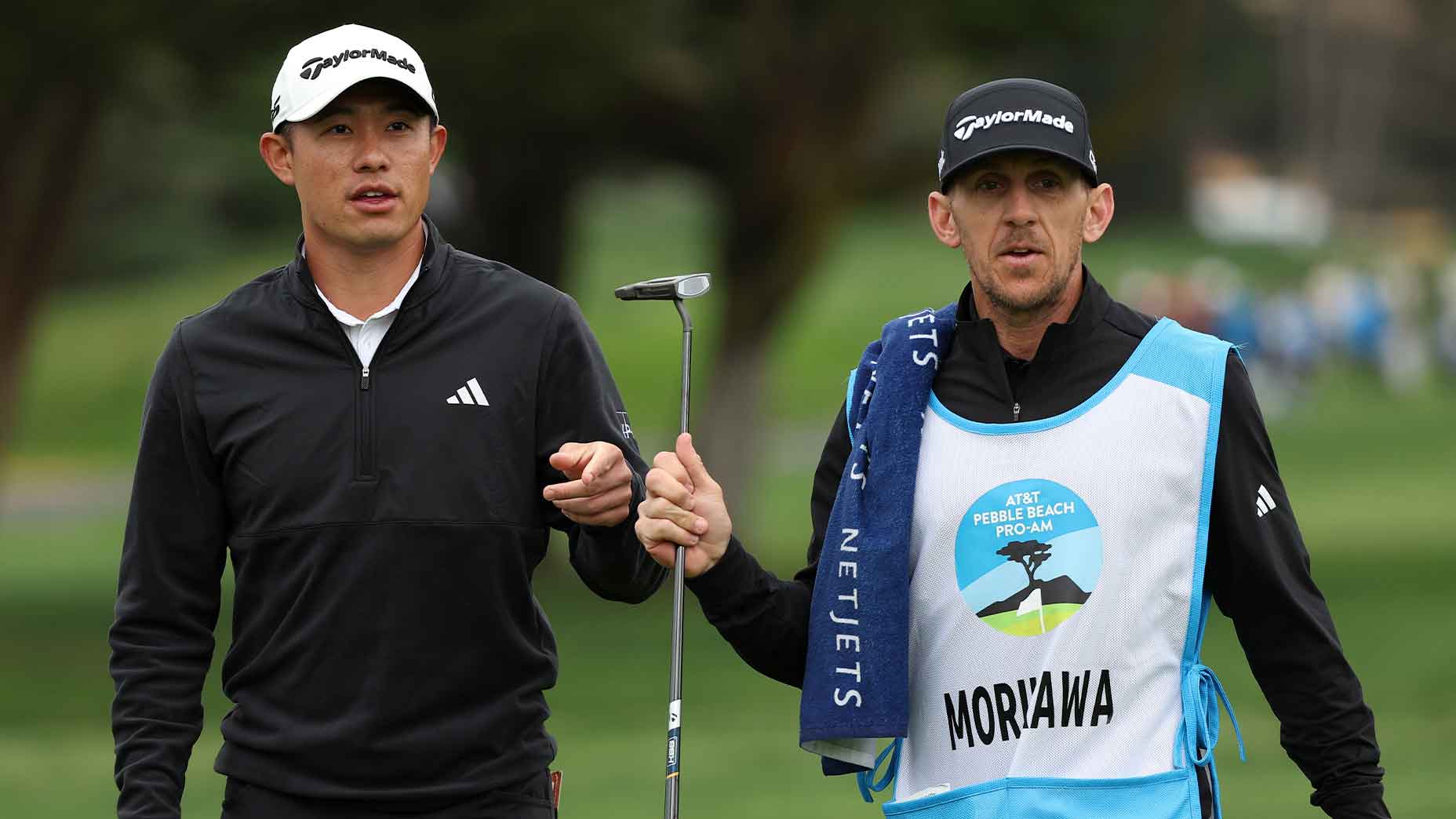 collin morikawa holds his putter at the ATT pebble beach pro-am.