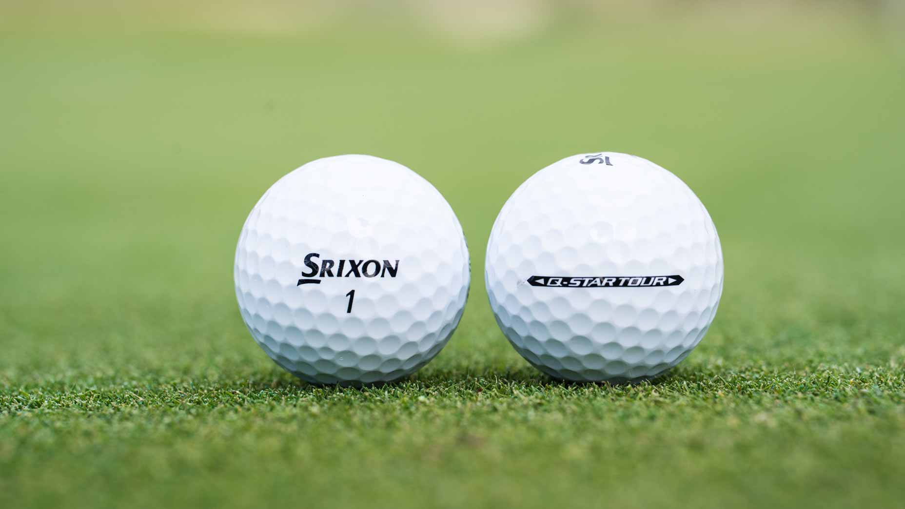 Srixon Q-Tour golf balls on grass.
