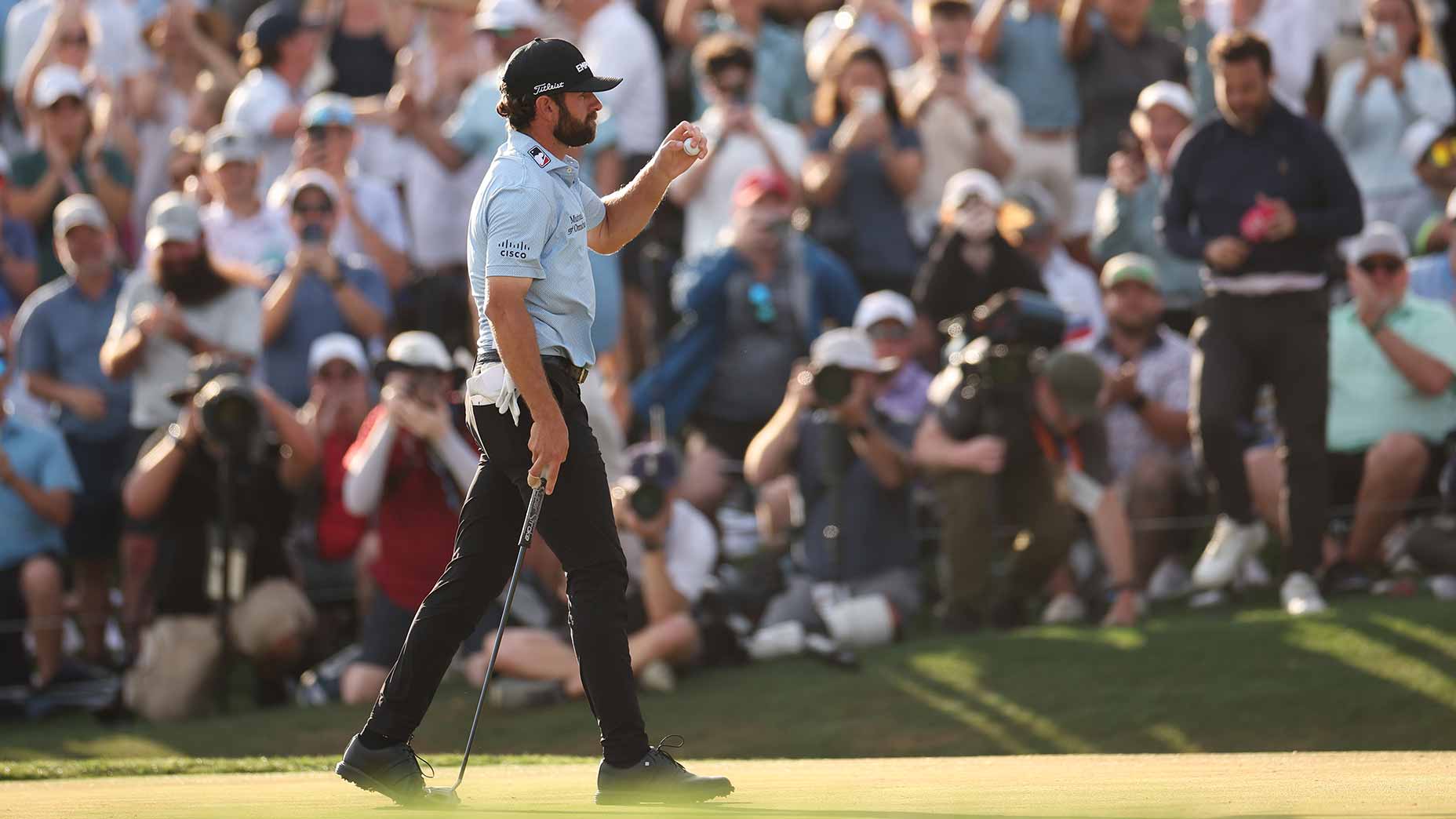 cameron young pumps fist at the players championship in blue shirt