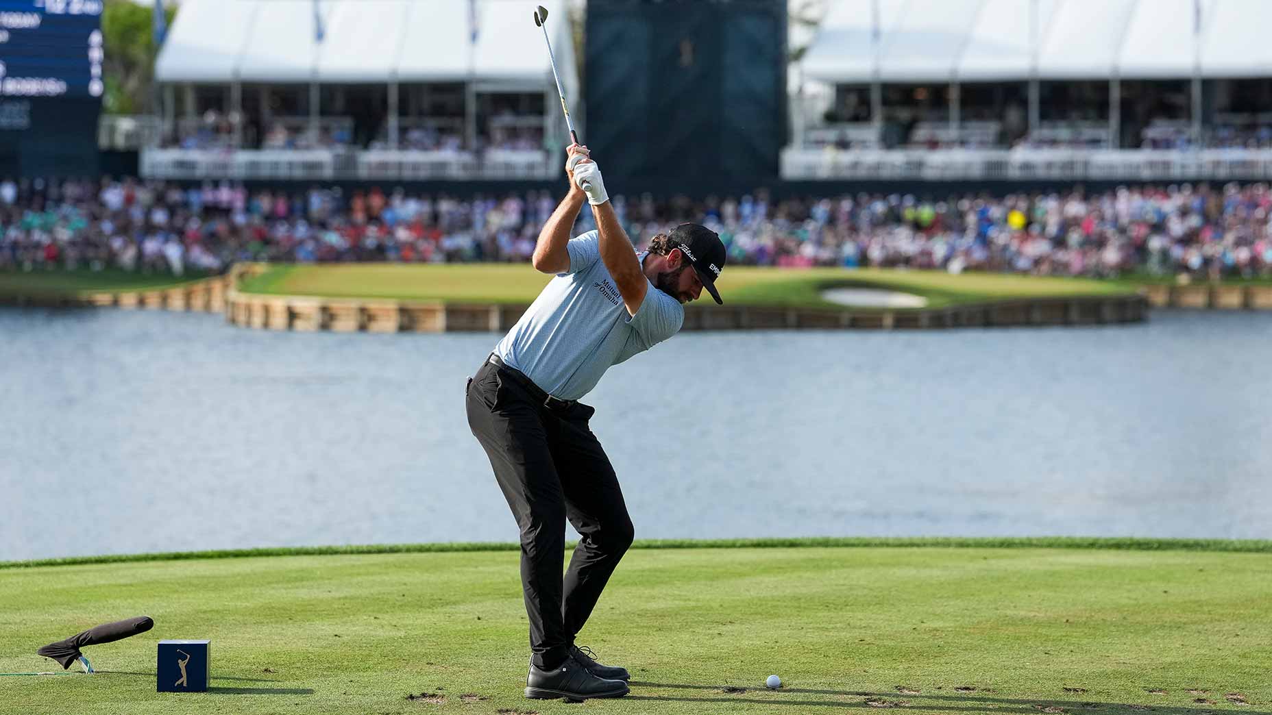 cameron young swings tee shot on the 17th green at TPC Sawgrass