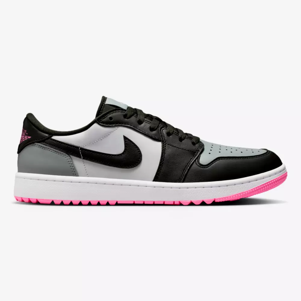 A Nike Air Jordan 1 Low sneaker with black, grey, and white leather panels, a black Swoosh, and a pink outsole—perfect for those seeking the best Jordan golf shoes with style. Features include black laces, a white midsole, and perforated toe box.