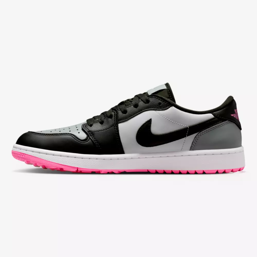 A low-top sneaker with a black, white, and gray leather upper, black laces and swoosh, a white midsole, and a pink outsole—turning heads like the best Jordan golf shoes on the course.