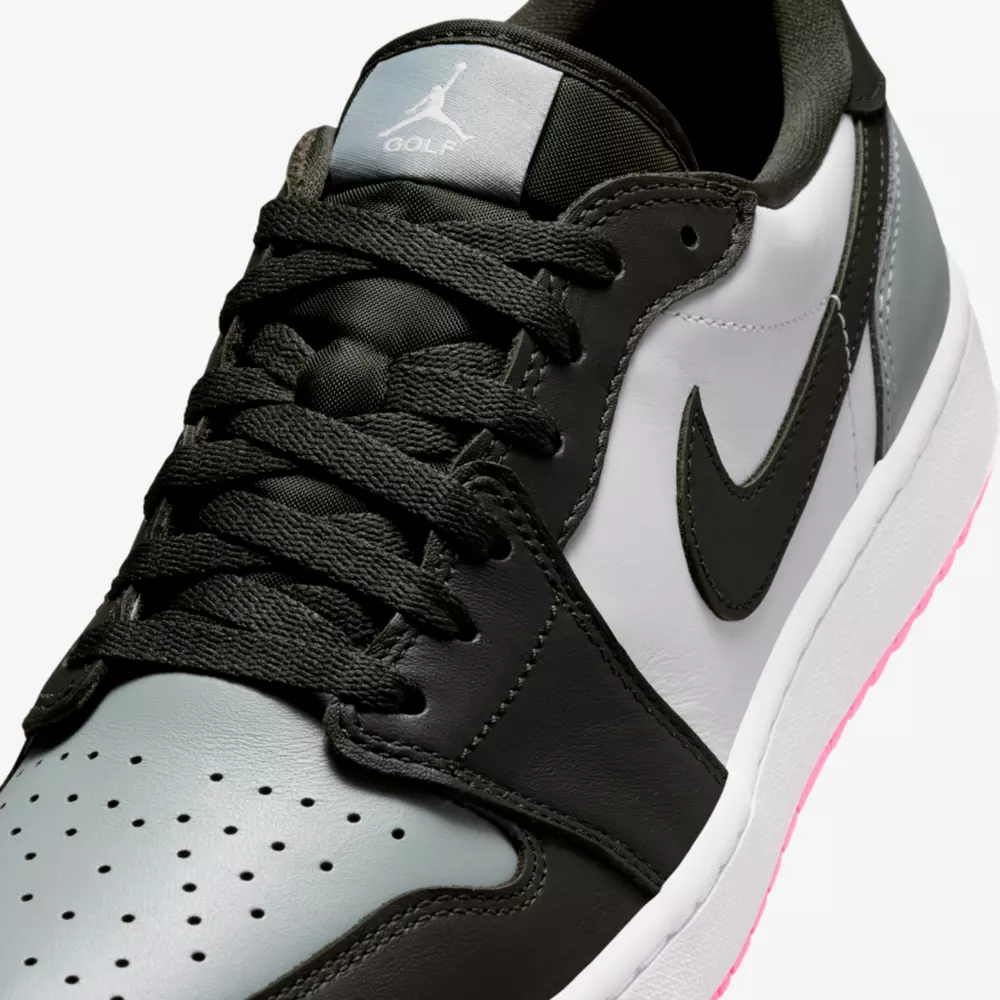 Close-up of one of the best Jordan golf shoes: Nike Air Jordan, featuring black laces, black and grey upper with a white side panel, black Swoosh, perforated toe box, pink-tinted sole, and Jumpman logo on the tongue.