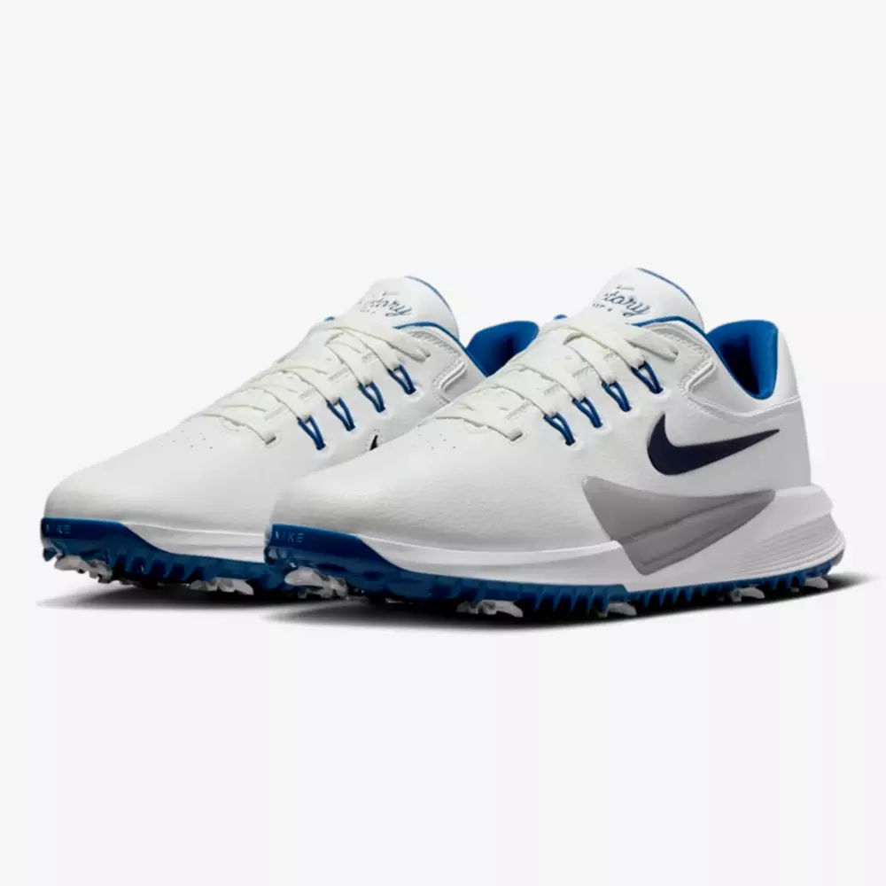 A pair of white athletic shoes with blue accents, blue Nike swooshes on the sides, and spiked soles&mdash;crafted for sports performance and style, making them contenders for the best golf shoes 2026.