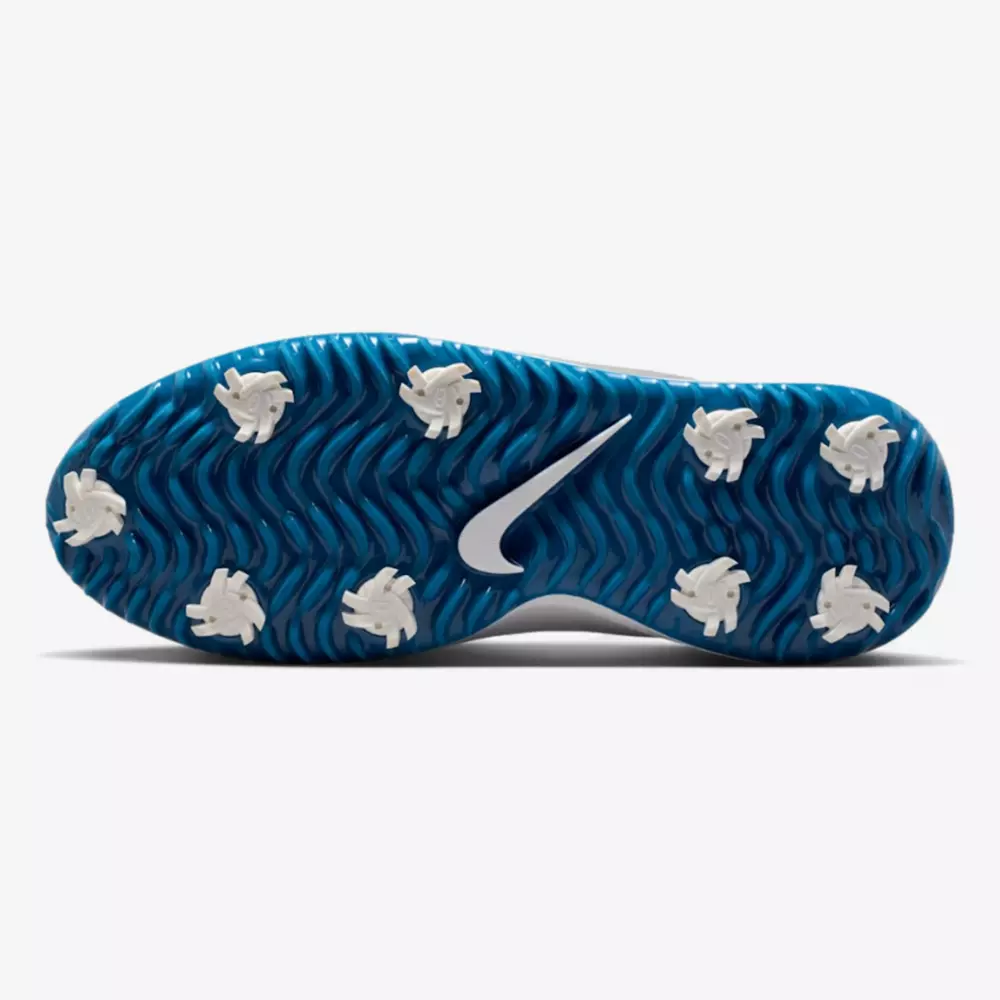 The image shows the sole of a golf shoe with a blue, wavy-textured base, eight white cleats, and a white Nike swoosh logo in the center—an innovative design that could set the standard for the best golf shoes 2026.