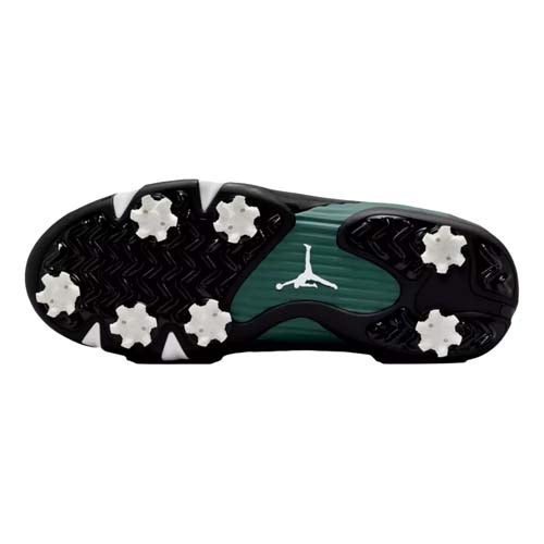 The image shows the sole of one of the best Jordan golf shoes, featuring six white spikes, a black and green tread, and a white Jumpman logo at the center.