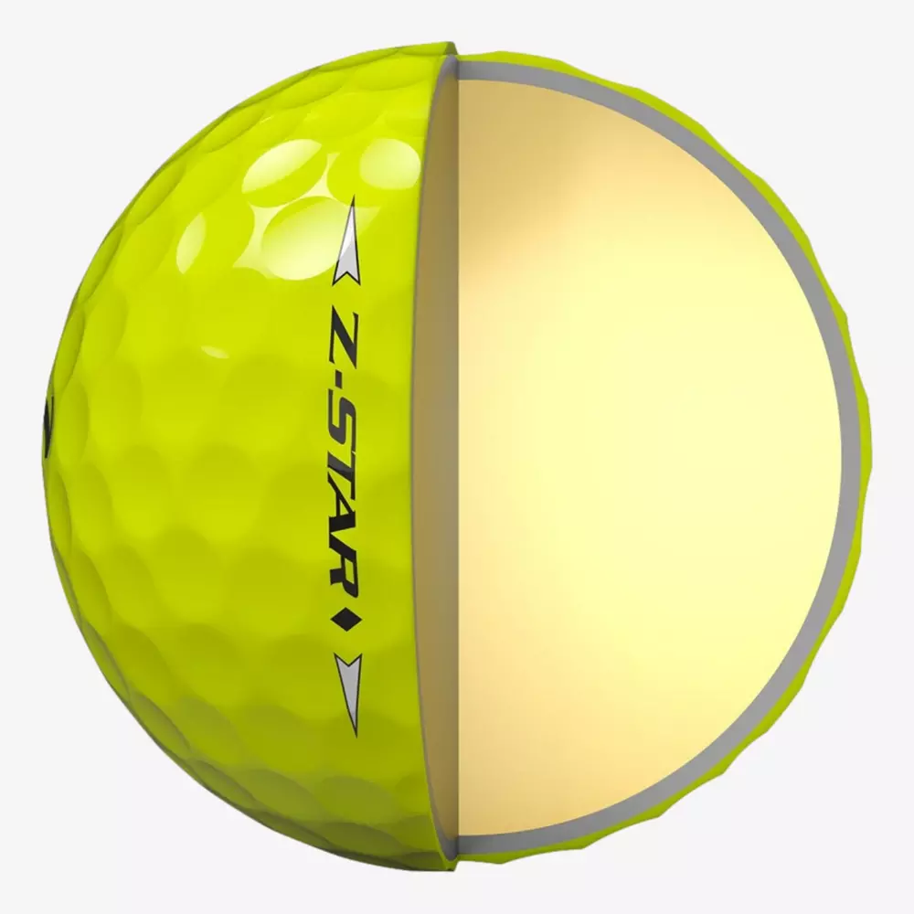 A yellow golf ball labeled Z-STAR is shown in half; the left side displays the dimpled exterior, while the right half reveals a smooth, solid inner core—an example of innovation seen in the best golf balls 2026.