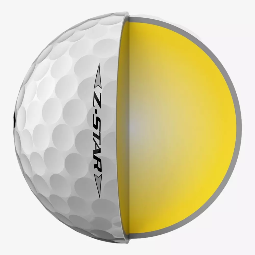 A golf ball labeled Z-STAR is shown cut in half, revealing its yellow inner core and textured white outer layer with dimples—the perfect companion for those searching for the best golf shoes 2026.