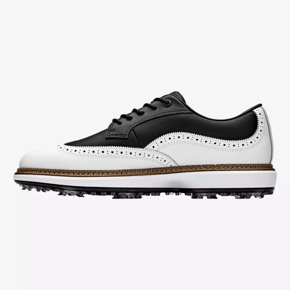 A black and white leather wingtip golf shoe with decorative perforations, black laces, and a textured sole designed for traction, inspired by the style of the best Jordan golf shoes.