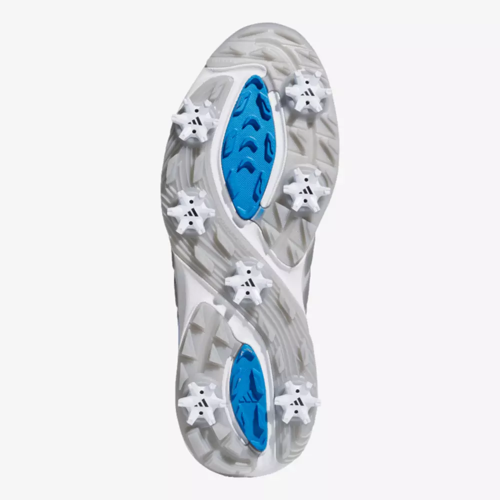 The image shows the sole of one of the best Jordan golf shoes, featuring six white cleats and blue accents for traction. The wavy tread pattern combines gray and white tones for both style and performance.