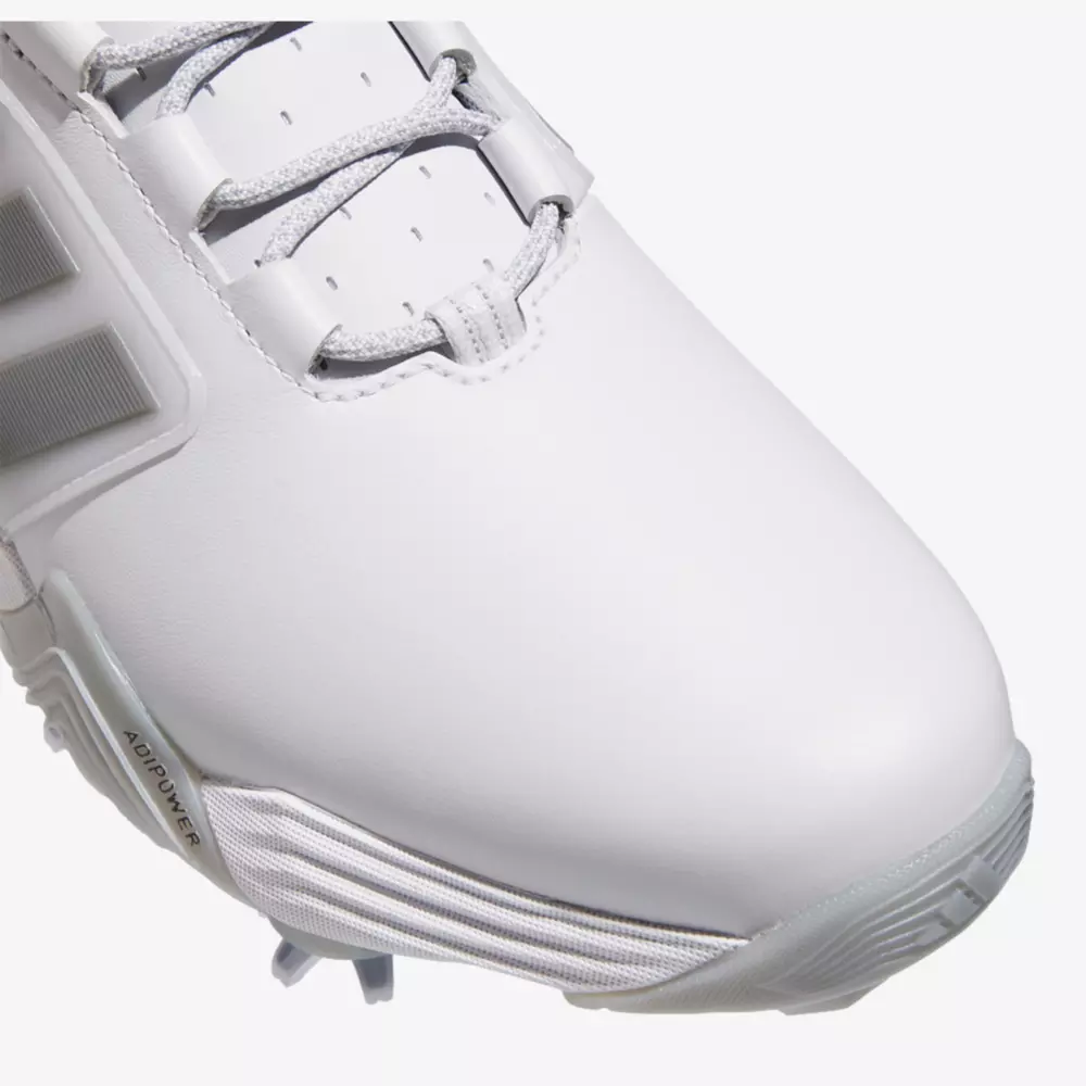 Close-up of the front and side of a white athletic shoe with gray laces and textured gray sole, showing detailed stitching and part of the Adidas logo on the side—perfect for those seeking performance similar to the best Jordan golf shoes.
