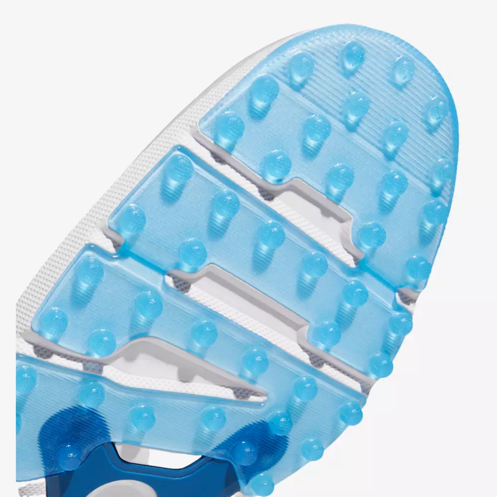 Close-up of a light blue athletic shoe sole with raised rubber studs and grooves, designed for traction on turf or grass surfaces—ideal for those seeking the best Jordan golf shoes. The background is white.