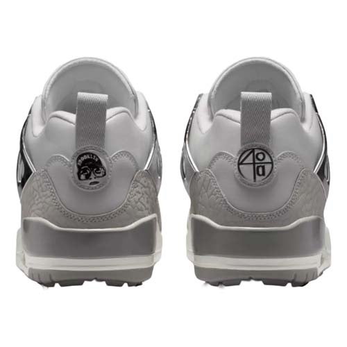 Back view of a pair of white, gray, and black golf shoes—designed with patterned heel accents and unique circular logos on the heel tabs—offering style inspired by the best Jordan golf shoes.