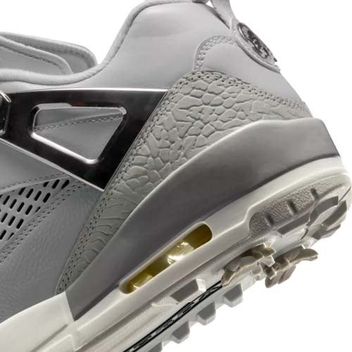 Close-up of a gray and white athletic sneaker, featuring textured and smooth materials, a visible air cushion in the sole, and a rugged, patterned outsole for traction—echoing the style found in the best Jordan golf shoes.