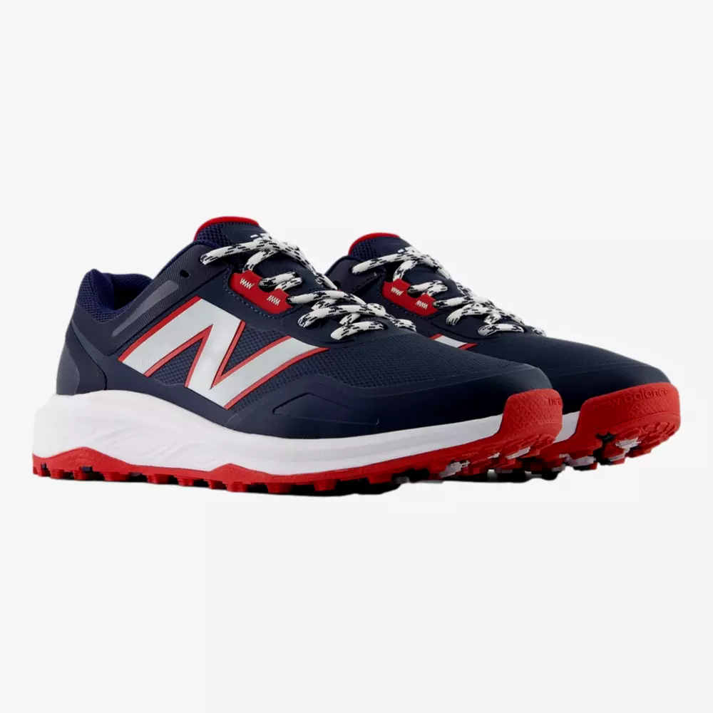 A pair of navy blue athletic sneakers with red and white accents, large white N logos on the sides, red soles, and patterned white and black laces—perfect for those seeking style beyond the best Jordan golf shoes—displayed on a white background.