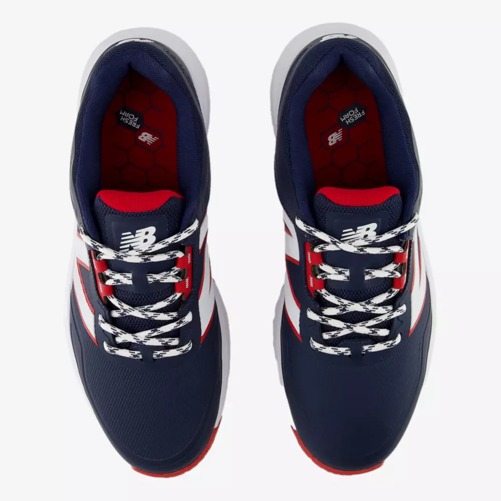 Top view of a pair of navy blue New Balance sneakers with white laces, red accents, and white midsoles on a white background. The insoles have a red pattern and the NB logo is visible on the tongue—an alternative to the best Jordan golf shoes.