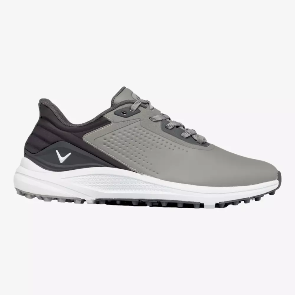 A gray and black athletic sneaker with a white sole, textured grip, and a small white checkmark logo on the heel side. Inspired by the best Jordan golf shoes, it features matching gray laces and a padded collar for comfort.