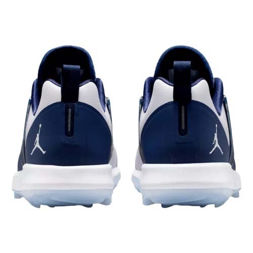 Back view of a pair of navy blue and white athletic shoes with the Jordan Jumpman logo on the heel—these could be among the best Jordan golf shoes, featuring white midsoles and dark blue accents on the upper and heel tab.