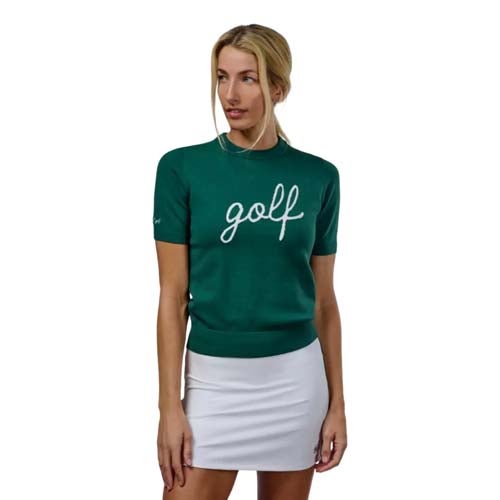 A woman wearing a green short-sleeve sweater with 