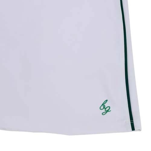 Close-up of the bottom edge of a white garment, featuring a thin green vertical stripe and small green bg initials embroidered near the hem—one of the best looks from The First Major.
