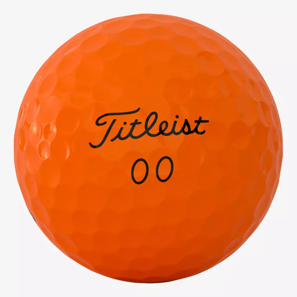 A close-up of an orange Titleist golf ball with the number 00 printed below the brand name in black text—perfect for your next round in the best golf shoes 2026 has to offer.