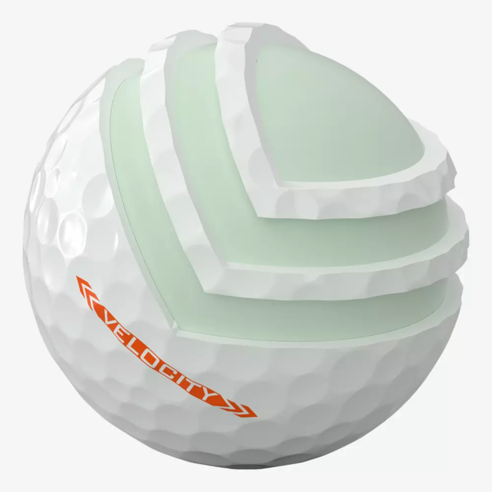 A golf ball with a cutaway section reveals its layered internal structure. The white, dimpled outer layer and orange “VELOCITY” label stand out—perfect for players searching for the best golf shoes 2026 to elevate their game.