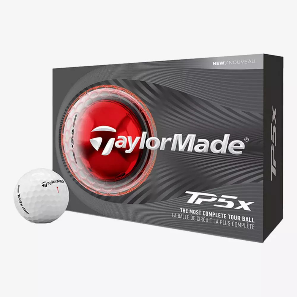 A box of TaylorMade TP5x golf balls is shown, featuring a close-up image of a golf ball and red core on the packaging. One white TaylorMade golf ball sits beside the box—perfect for pairing with the best golf shoes 2026 has to offer.
