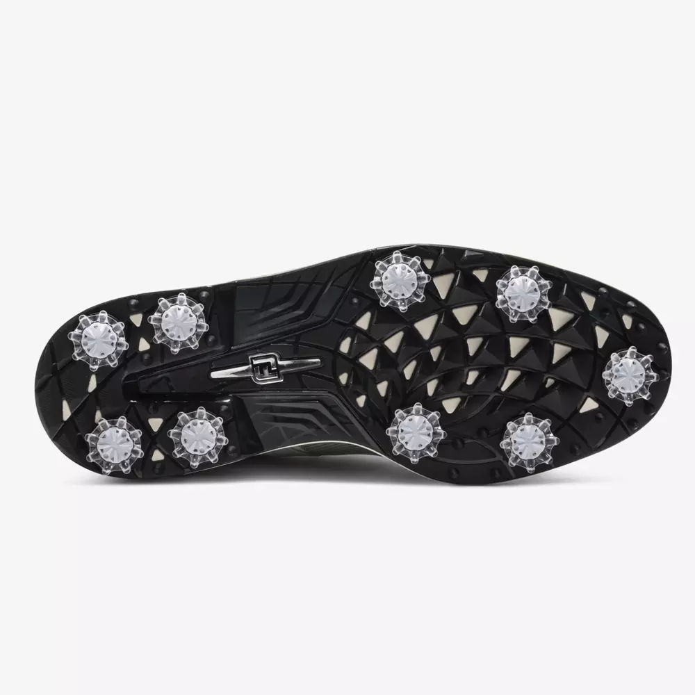 The underside of a black golf shoe, similar to the best Jordan golf shoes, features multiple clear spikes and a patterned tread designed for optimum grip and stability on grassy surfaces.