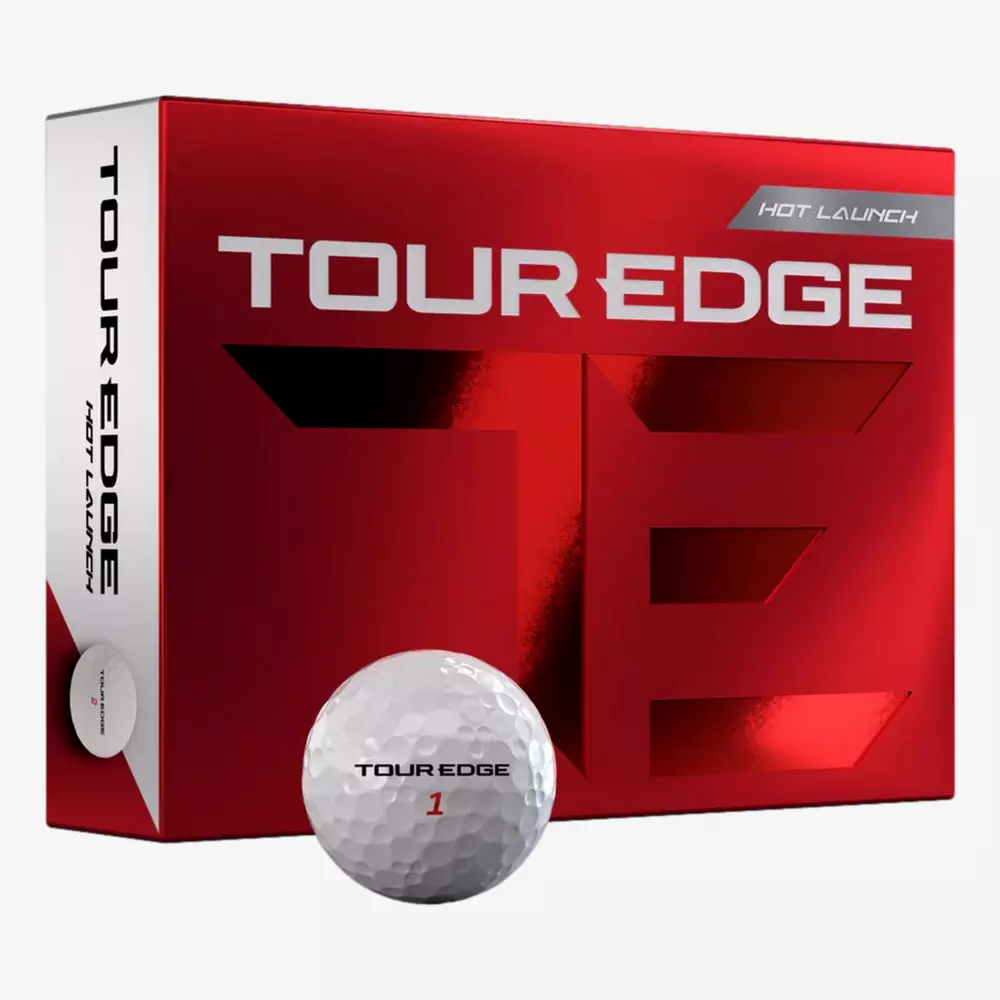 A red and silver box labeled TOUR EDGE HOT LAUNCH sits next to a white golf ball marked TOUR EDGE 1, shown against a plain white background—the perfect setup to pair with the best golf shoes 2026 for your next round.