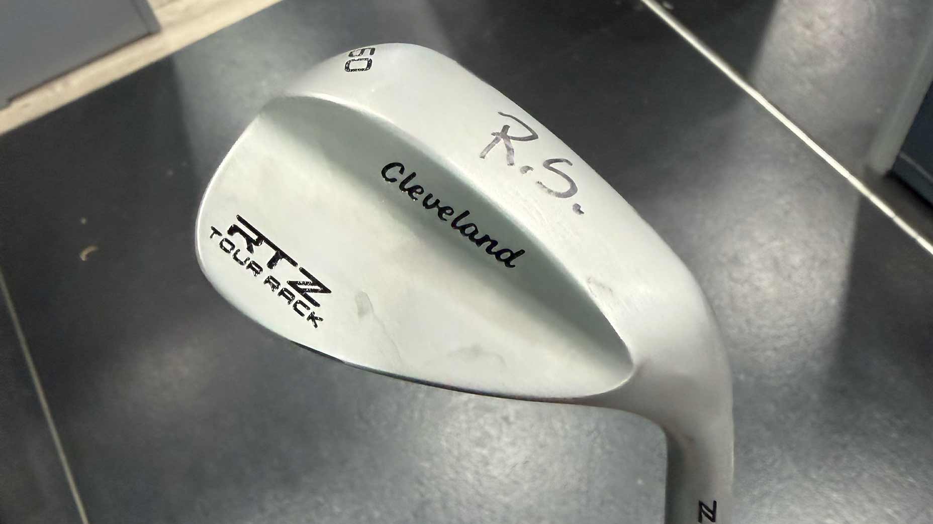 A close-up of a silver Cleveland RTZ Tour Rack wedge.