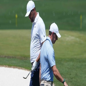 Scottie Scheffler and Rory McIlroy pass each other during the final day of the 2026 Masters.