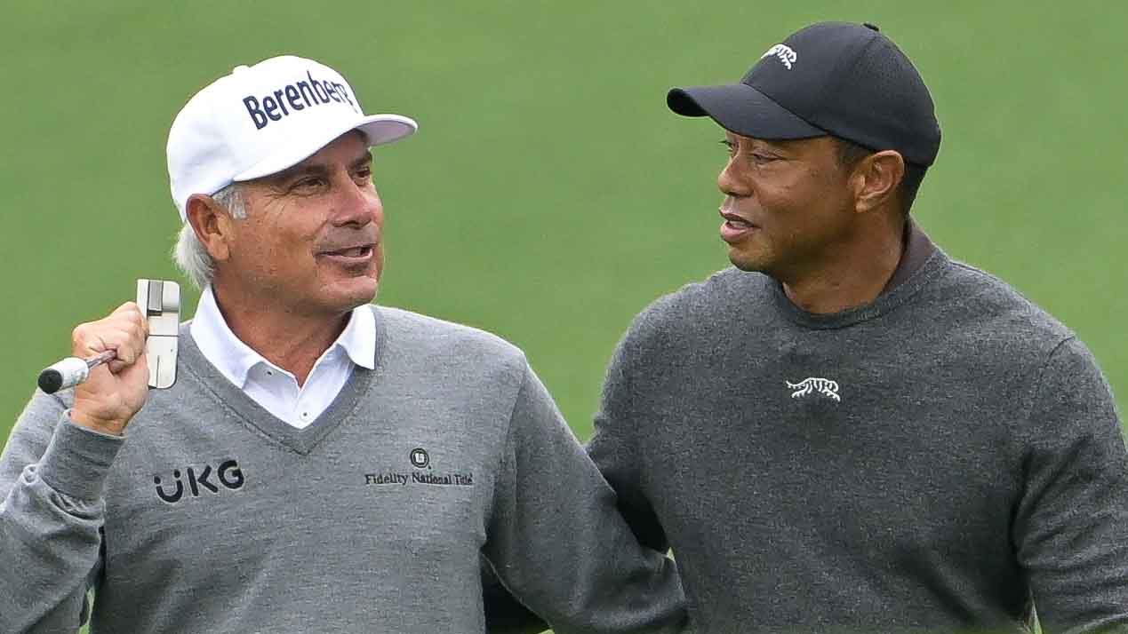 Tiger Woods and Fred Couples hug while walking together on the ninth fairway prior to Masters Tournament at Augusta National Golf Club on April 9, 2024