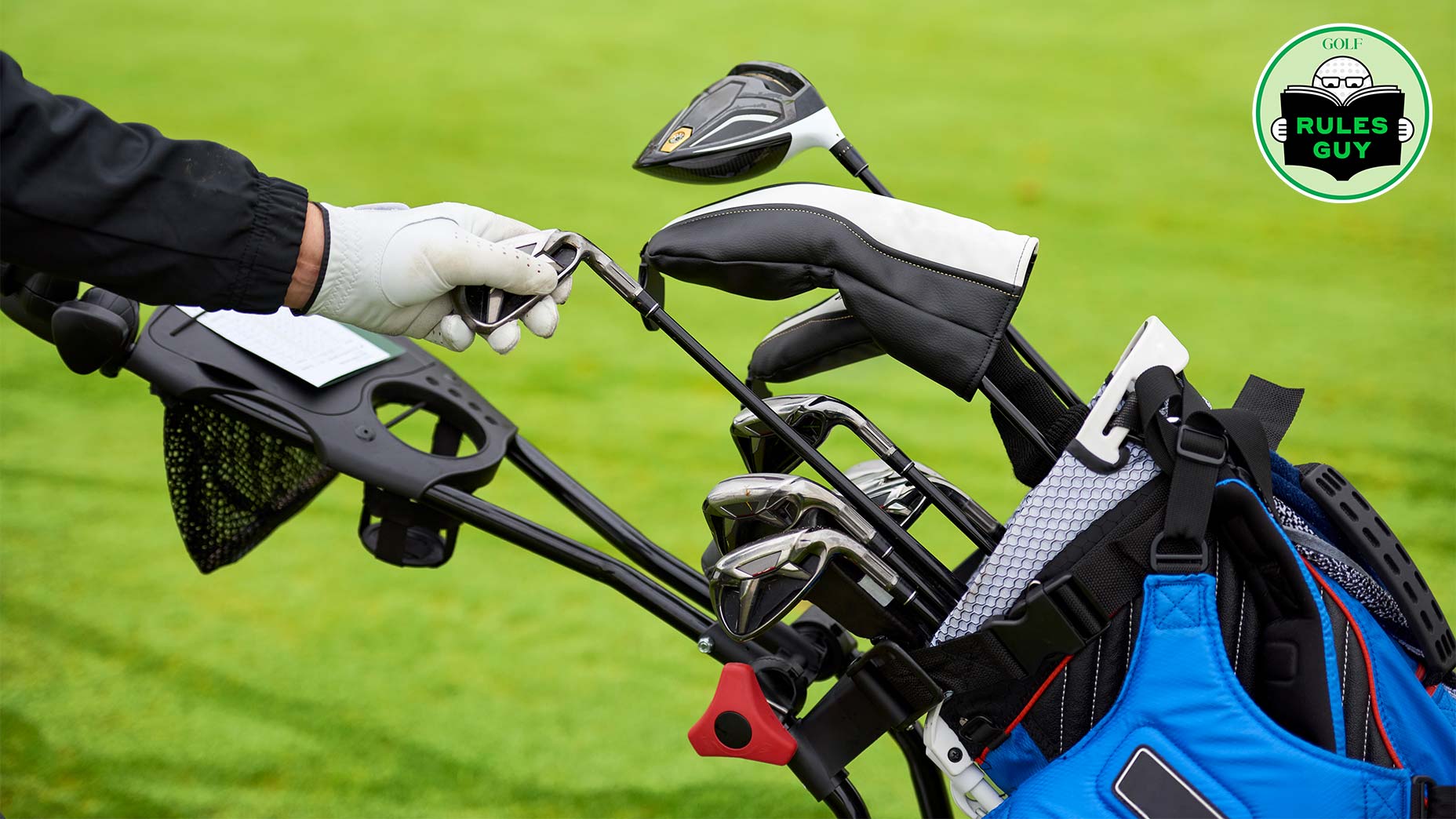A gloved hand selects a golf club from a golf bag on a pushcart, with several other clubs visible against a blurred green grass background. A Rules Guy logo in the upper right hints at club count and key golf rules to remember.