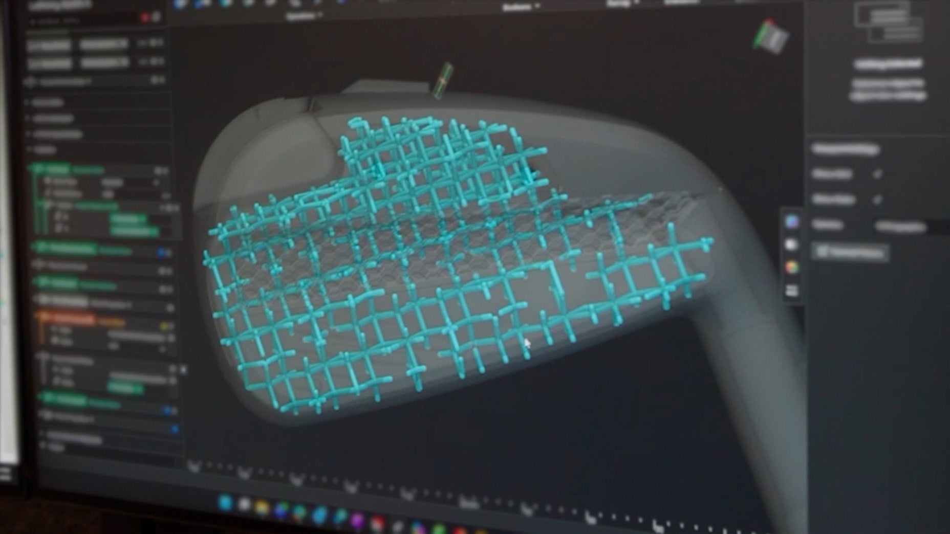A computer screen displays a 3D model with blue grid structures overlaid, likely representing internal features or analysis of Cobra 3DP Irons, possibly a mechanical part, in a design or engineering software.