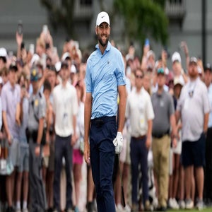 2026 Cadillac Championship odds: Scottie Scheffler in a light blue shirt and white cap smiles while holding his golf club.