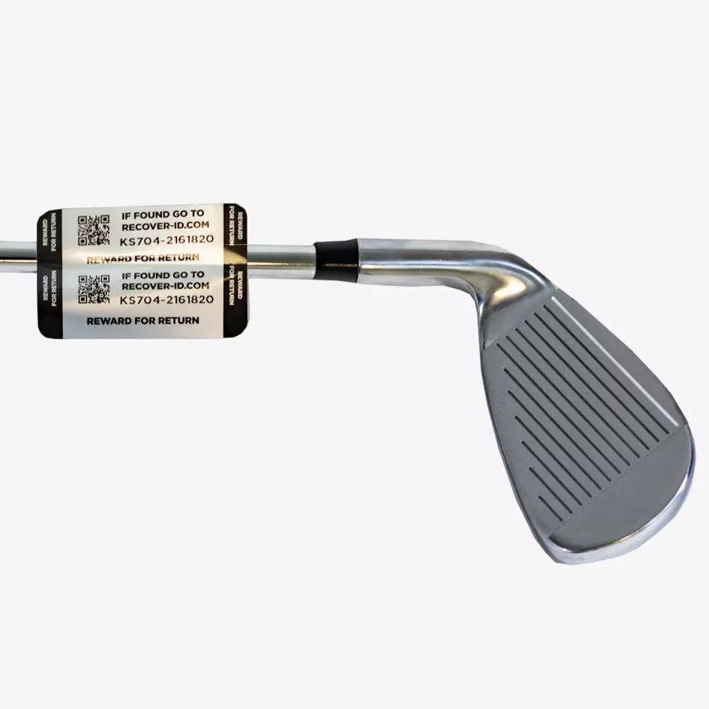 A close-up of a metal golf club iron with a black and silver Lost & Found label on the shaft, displaying QR codes and recovery info—ideal for golfers looking to keep their gear secure alongside the best golf bags 2026 has to offer.
