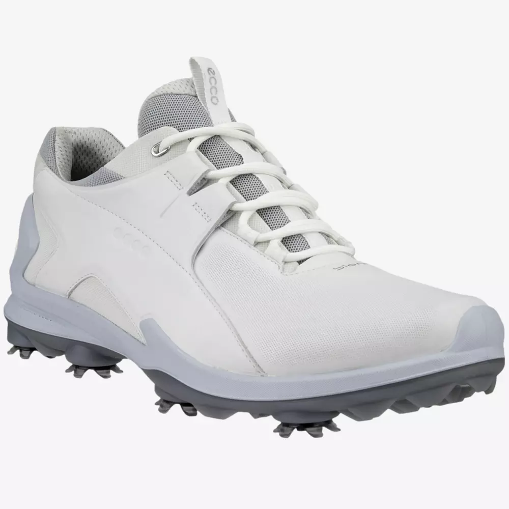 A white athletic golf shoe with gray accents, mesh tongue, and spiked sole designed for traction on grass surfaces—one of the best golf deals for $100 or less.