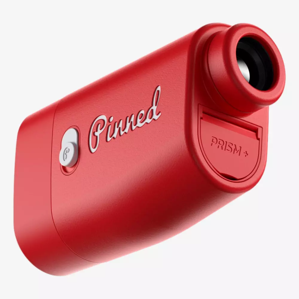 A red golf rangefinder labeled Pinned with a lens on one end, a button on the side, and a compartment labeled Prism+ on the front—perfect for golfers searching for the best deals under $50.