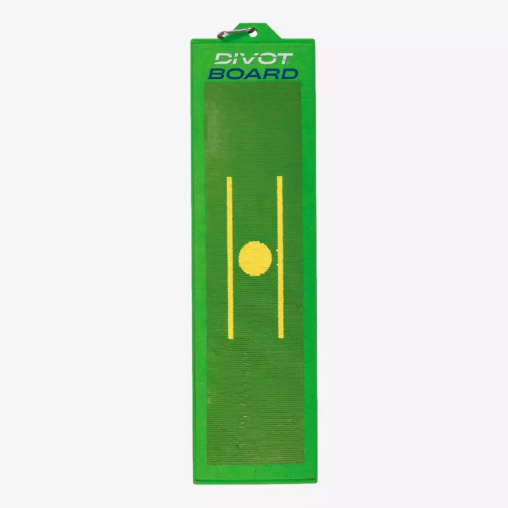 A rectangular green divot board with a yellow circle and two parallel yellow lines in the center, used for golf swing practice. The words DIVOT BOARD appear at the top—one of the best deals under $50 for golf training aids.