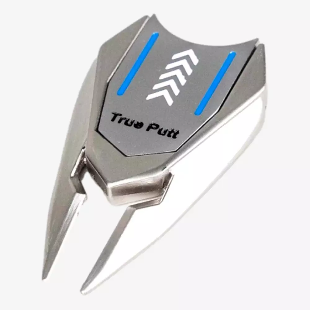 A metallic golf ball marker and divot tool labeled True Putt, featuring two prongs, blue lines, and white arrow designs on a silver surface—an ideal accessory to pair with the best golf bags 2026 has to offer.