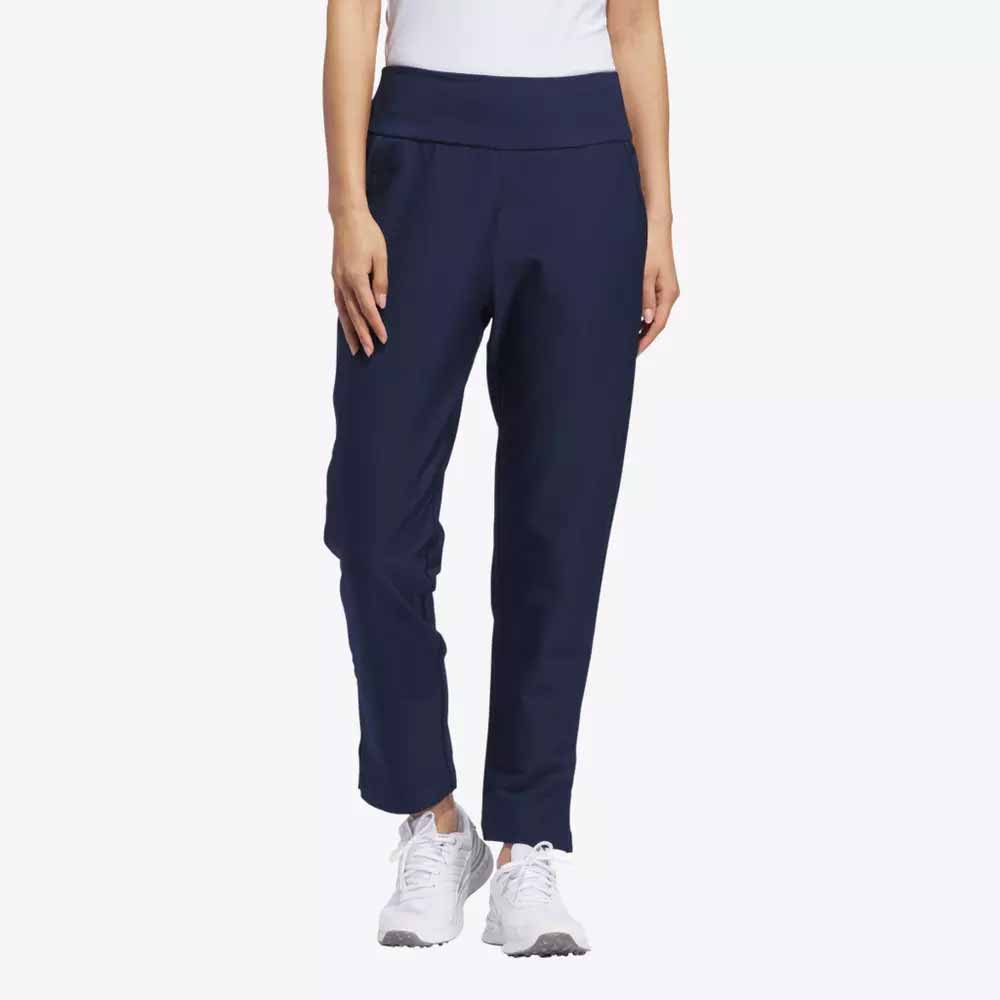 A person models navy blue jogger pants, a white top, and white sneakers—stylish apparel perfect for Mother’s Day. The image is cropped at the shoulders with a plain light background.