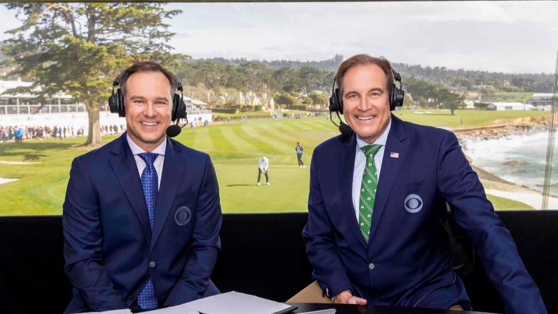 Two male sports commentators in suits, headsets on, sit at a broadcast desk with papers. Behind them, Trevor Immelman lines up a putt on the green, watched by spectators—with an air of neurotic readiness in the tense atmosphere.